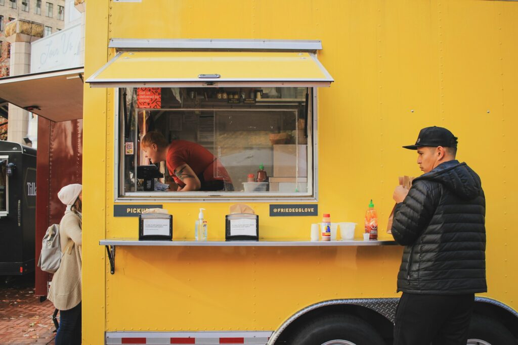 man getting food from a food truck